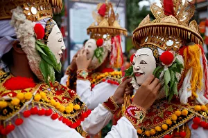Balinese Hindus wear masks as they prepare before performing sacred Telek dance at Balinese Hindus wear masks as they prepare before performing sacred Telek dance at