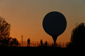 A balloon is silhouetted at sunset near the Spree river in Berlin A balloon is silhouetted at sunset near the Spree river in Berlin