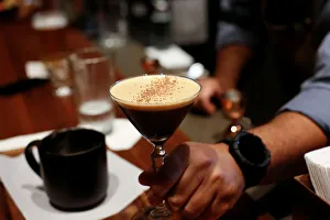 A bartender serves an espresso martini to a customer at the mixology bar as Starbucks A bartender serves an espresso martini to a customer at the mixology bar as Starbucks