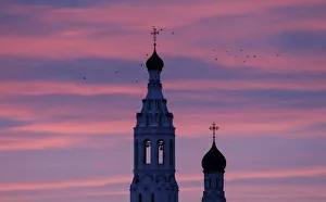 Birds fly over the Annunciation church at dawn in the village of Lipitsy Birds fly over the Annunciation church at dawn in the village of Lipitsy