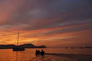 Boat sails near a sailboat moored in the harbour of La Punta, against the backdrop Boat sails near a sailboat moored in the harbour of La Punta, against the backdrop