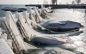 Boats are covered with a thick layer of ice at Lake Constance in the port of Romanshorn Boats are covered with a thick layer of ice at Lake Constance in the port of Romanshorn