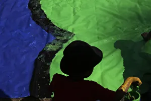 A boy paints during a Guinness World Record event as part of celebrations for the A boy paints during a Guinness World Record event as part of celebrations for the