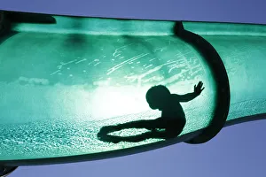 A boy slides down a water chute in a public swimming pool in Thun A boy slides down a water chute in a public swimming pool in Thun