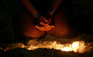 Images Dated 31st December 2005: Brazilian woman prays on Copacabana beach in Rio de Janeiro