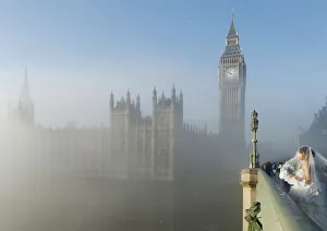 A bride poses for a photograph on Westminster Bridge as the fog clears in central London A bride poses for a photograph on Westminster Bridge as the fog clears in central London
