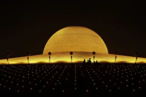 Buddhist monks hold candles and pray at the Wat Phra Dhammakaya temple in Pathum Thani Buddhist monks hold candles and pray at the Wat Phra Dhammakaya temple in Pathum Thani