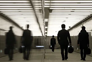 Businessmen walk through a business complex in Tokyo Businessmen walk through a business complex in Tokyo