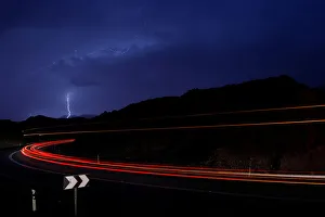 Cars drive as lightning strikes near the site where a group of Israeli youths was swept Cars drive as lightning strikes near the site where a group of Israeli youths was swept