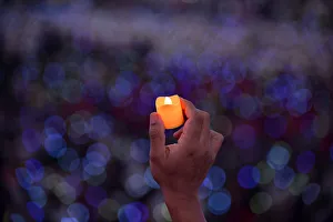 Catholic faithful hold up LED candles as Pope Francis attends a meeting with Filipino Catholic faithful hold up LED candles as Pope Francis attends a meeting with Filipino