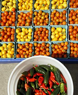 Cherry tomatoes and hot peppers are displayed for sale at the Food Projects Farmer's Cherry tomatoes and hot peppers are displayed for sale at the Food Projects Farmer's