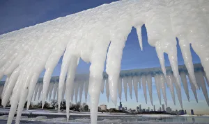 Chicago skyline is framed by icicles in Chicago Chicago skyline is framed by icicles in Chicago