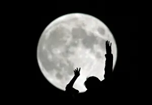 A Chinese boy plays during a full moon night in Shanghai A Chinese boy plays during a full moon night in Shanghai
