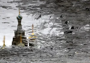 The Church of the Savior on Spilled Blood is reflected in melting ice on Arts Square in The Church of the Savior on Spilled Blood is reflected in melting ice on Arts Square in