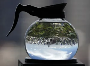 A coffee pot filled with water acts as a lens to depict Lumpini Park in Bangkok A coffee pot filled with water acts as a lens to depict Lumpini Park in Bangkok