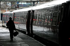Commuter walks to board a train at Kings Cross station in central London Commuter walks to board a train at Kings Cross station in central London