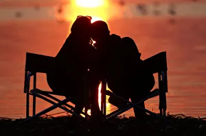 Couple enjoys a sunset at a lake on the outskirts of Minsk Couple enjoys a sunset at a lake on the outskirts of Minsk