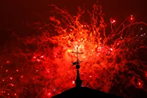 A cross of the Basilica of the Agustinas Recoletas is seen as fireworks explode over the A cross of the Basilica of the Agustinas Recoletas is seen as fireworks explode over the