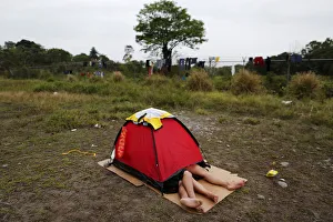 A Cuban migrant couple rests inside a tent at a provisional shelter in Paso Canoas A Cuban migrant couple rests inside a tent at a provisional shelter in Paso Canoas
