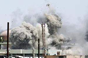 Debris fly as smoke rises after an artillery attack to the Islamic State militants Debris fly as smoke rises after an artillery attack to the Islamic State militants