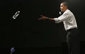 Democratic presidential candidate Senator Barack Obama throws a bottle of water to Democratic presidential candidate Senator Barack Obama throws a bottle of water to