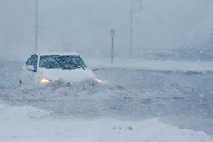 Drivers make their way along the flooded Beach Road after the ocean overtopped the Drivers make their way along the flooded Beach Road after the ocean overtopped the