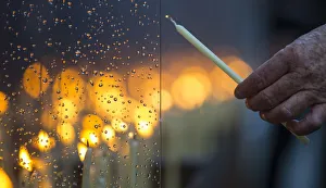 An elderly person lights a candle at the Berlin Wall memorial in Bernauer Strasse after a An elderly person lights a candle at the Berlin Wall memorial in Bernauer Strasse after a