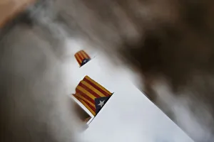 Esteladas are reflected in a puddle of water three days after the banned independence Esteladas are reflected in a puddle of water three days after the banned independence