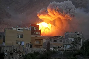 Fire and smoke billows from an army weapons depot after it was hit by an air strike in Fire and smoke billows from an army weapons depot after it was hit by an air strike in