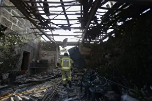A fireman walks through a destroyed house after an explosion in a fireworks storage A fireman walks through a destroyed house after an explosion in a fireworks storage