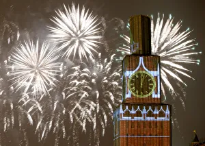 Fireworks light the sky over the Kremlins Spasskaya Tower, covered by scaffolding Fireworks light the sky over the Kremlins Spasskaya Tower, covered by scaffolding