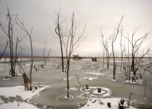 Fishermen break the ice to save the fish at the frozen Dojran lake Fishermen break the ice to save the fish at the frozen Dojran lake
