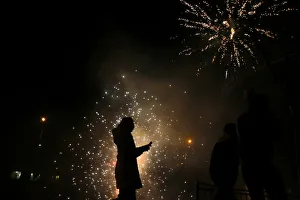 A girls walks as residents set off fireworks as part of Chinese New Year celebrations A girls walks as residents set off fireworks as part of Chinese New Year celebrations