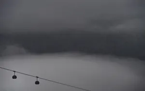 Gondolas are seeing amidst the fog ahead of the mens freestyle skiing halfpipe Gondolas are seeing amidst the fog ahead of the mens freestyle skiing halfpipe