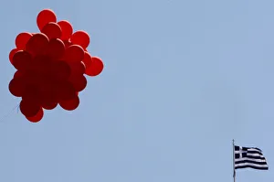 A Greek flag flutters next to balloons during a May Day rally at central Syntagma square A Greek flag flutters next to balloons during a May Day rally at central Syntagma square