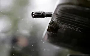 A gun is pictured as armed forces members patrol during an operation against drug dealers A gun is pictured as armed forces members patrol during an operation against drug dealers