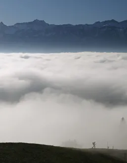 A hiker walks into a sea of fog over Lake Leman at the Tour de Gourze near Lausanne A hiker walks into a sea of fog over Lake Leman at the Tour de Gourze near Lausanne