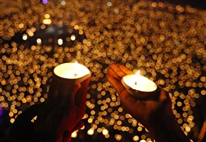 Hindu devotees hold earthen lamps to perform prayers called Aarti during the celebrations Hindu devotees hold earthen lamps to perform prayers called Aarti during the celebrations