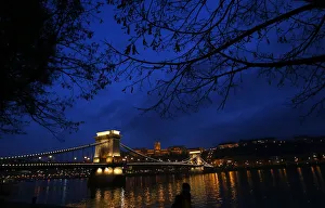 The iconic Chain Bridge of Budapest spans the Danube river and the Royal Palace is The iconic Chain Bridge of Budapest spans the Danube river and the Royal Palace is