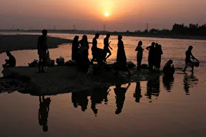 Indian labourers take a bath in the river Tawi in Jammu Indian labourers take a bath in the river Tawi in Jammu