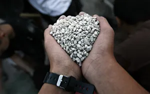 Israeli boy holds a fist full of gravel as he takes part in a building activity at the Israeli boy holds a fist full of gravel as he takes part in a building activity at the