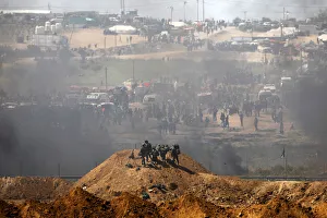 Israeli soldiers are seen next to the border fence on the Israeli side of the Israel-Gaza Israeli soldiers are seen next to the border fence on the Israeli side of the Israel-Gaza