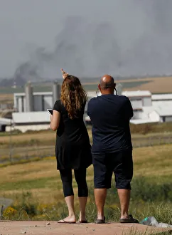 Israelis look at the Israel-Gaza border line as Palestinian protestors clash with Israeli Israelis look at the Israel-Gaza border line as Palestinian protestors clash with Israeli