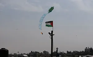 Kite is set on fire by Palestinians to be thrown at the Israeli side during clashes at a Kite is set on fire by Palestinians to be thrown at the Israeli side during clashes at a