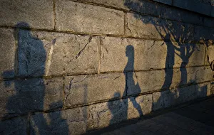 Late afternoon shadows are cast on the seawall along the inner harbour in Victoria Late afternoon shadows are cast on the seawall along the inner harbour in Victoria
