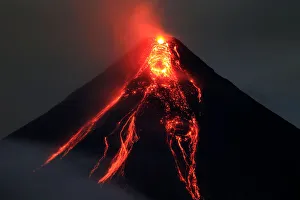 Lava flows from the crater of Mount Mayon volcano during a new eruption in Legazpi city Lava flows from the crater of Mount Mayon volcano during a new eruption in Legazpi city