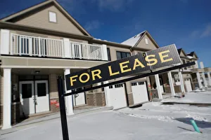 A For lease sign stands in front of a row of houses in a newly build subdivision in A For lease sign stands in front of a row of houses in a newly build subdivision in