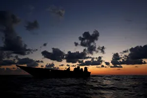 Libyan migrants on a wooden boat await rescue by the migrant search Libyan migrants on a wooden boat await rescue by the migrant search