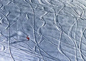 A lone snowboarder slides down a hill near the ski resort of Arosa A lone snowboarder slides down a hill near the ski resort of Arosa