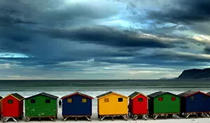 Images Dated 12th August 2003: LONE STROLLER STANDS BY BEACH HUTS IN CAPE TOWN